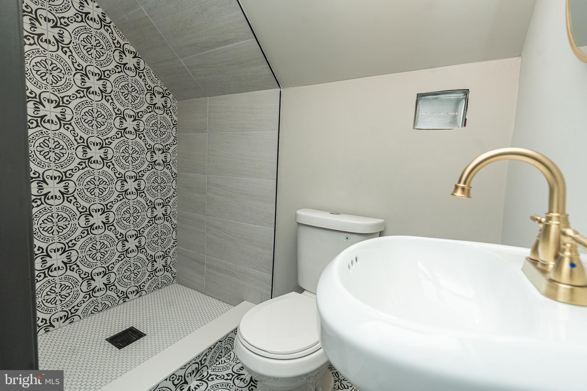 3910 Chatham Road Baltimore, MD 21207 - Photo 42 of 52 a white toilet sitting next to a shower