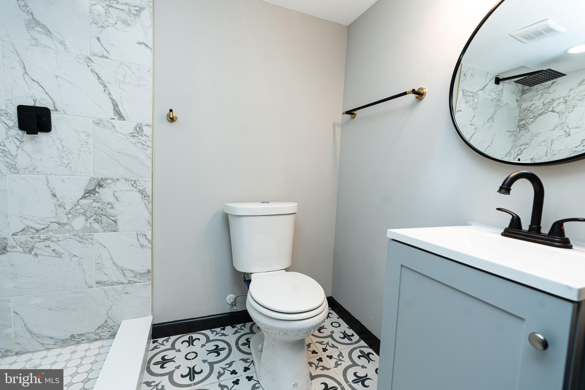 3910 Chatham Road Baltimore, MD 21207 - Photo 49 of 52 a bathroom with a toilet sink and mirror