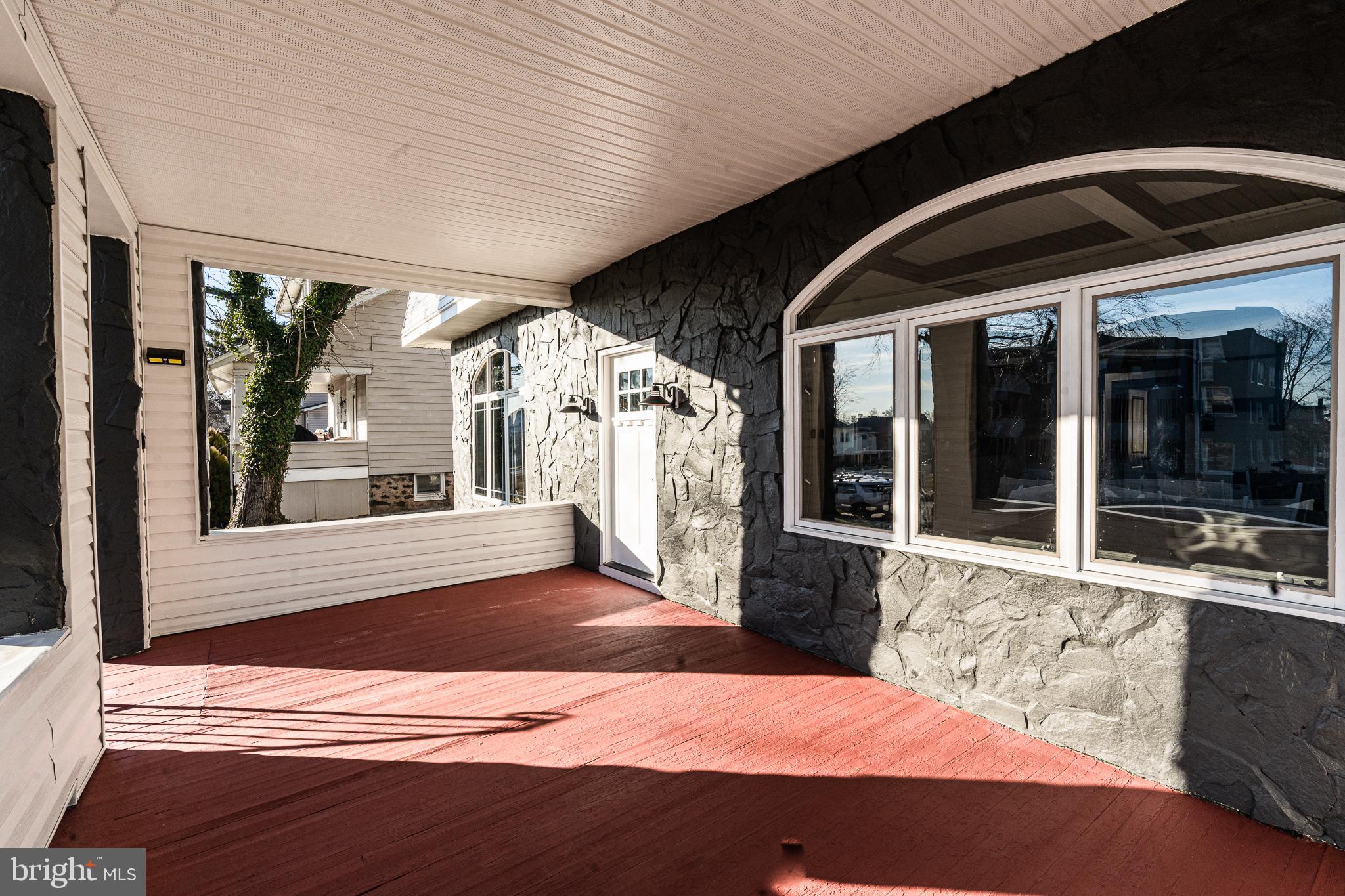 3910 Chatham Road Baltimore, MD 21207 - Photo 50 of 52 a view of a porch with a floor to ceiling window and an outdoor space