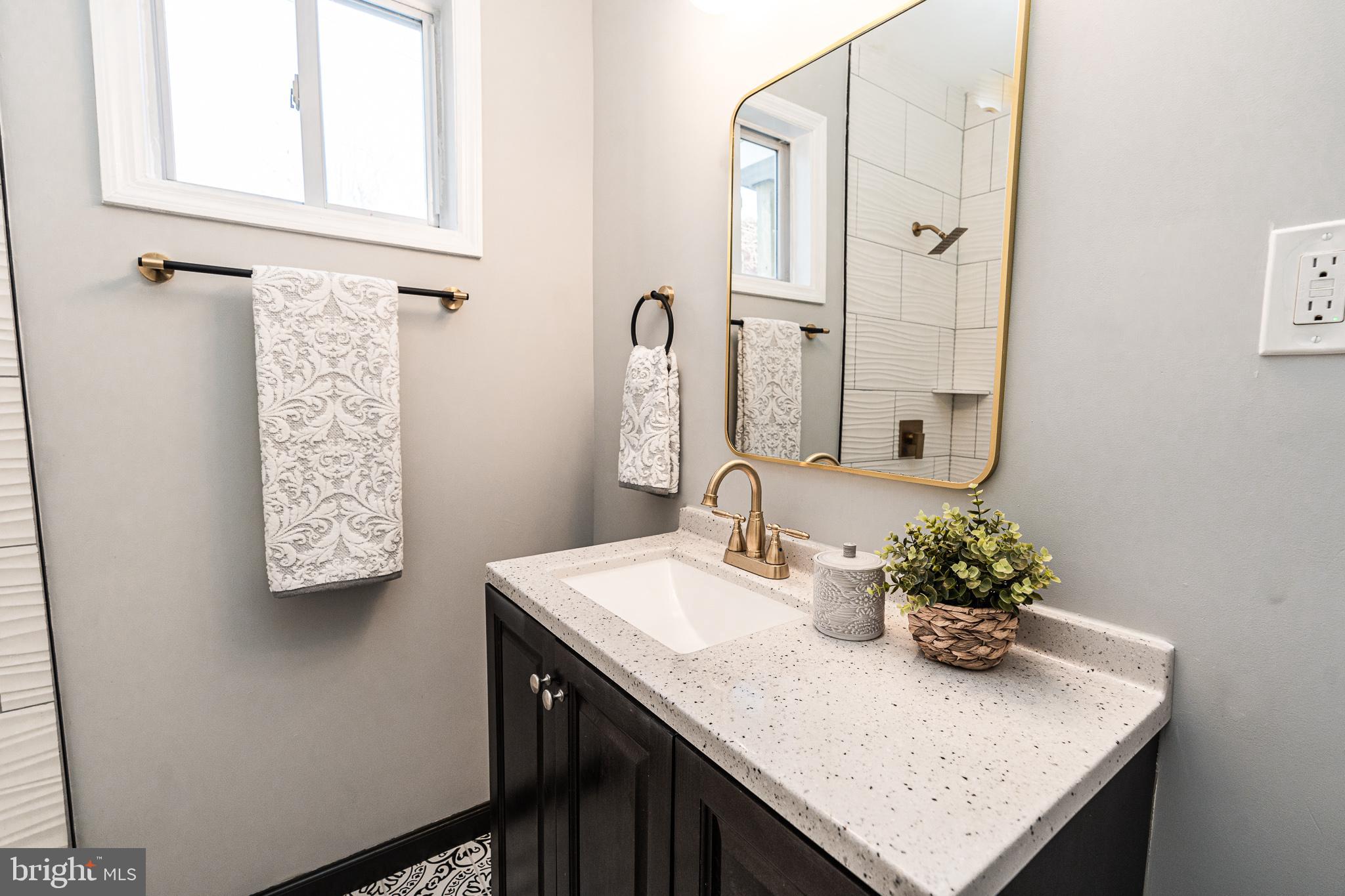 3910 Chatham Road Baltimore, MD 21207 - Photo 8 of 52 a bathroom with a sink a vanity and a mirror