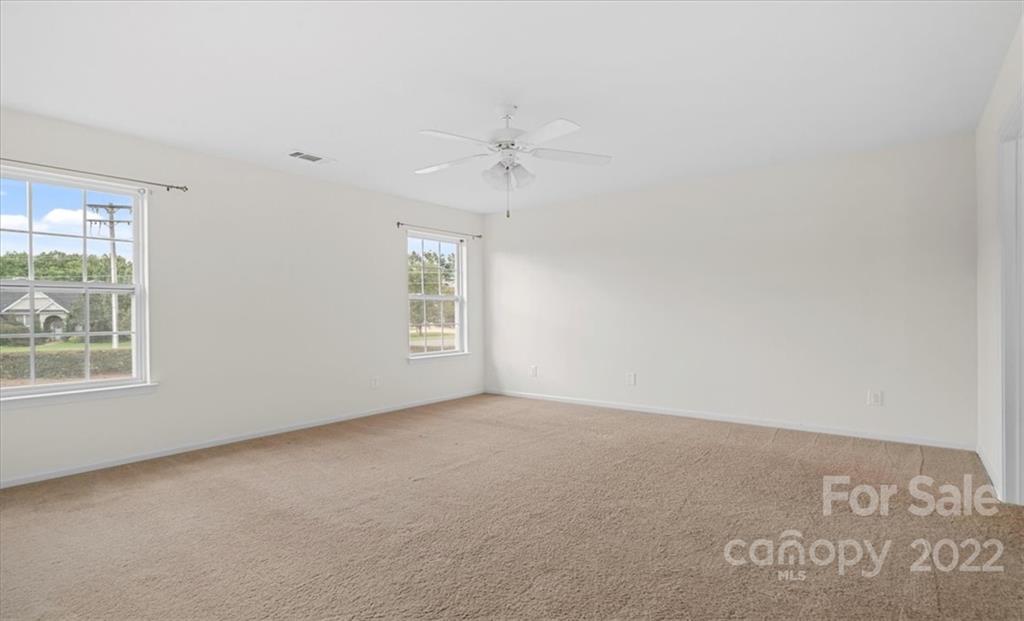1224 Afternoon Sun Road Matthews, NC 28104 - Photo 11 of 22 an empty room with windows and ceiling fan