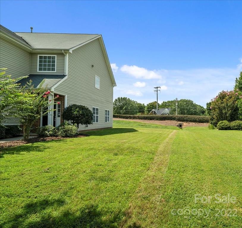 1224 Afternoon Sun Road Matthews, NC 28104 - Photo 20 of 22 a front view of a house with garden