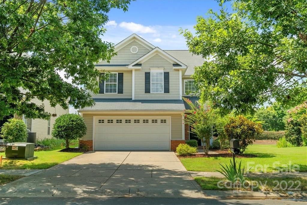 1224 Afternoon Sun Road Matthews, NC 28104 - Photo 2 of 22 a front view of a house with a yard and garage