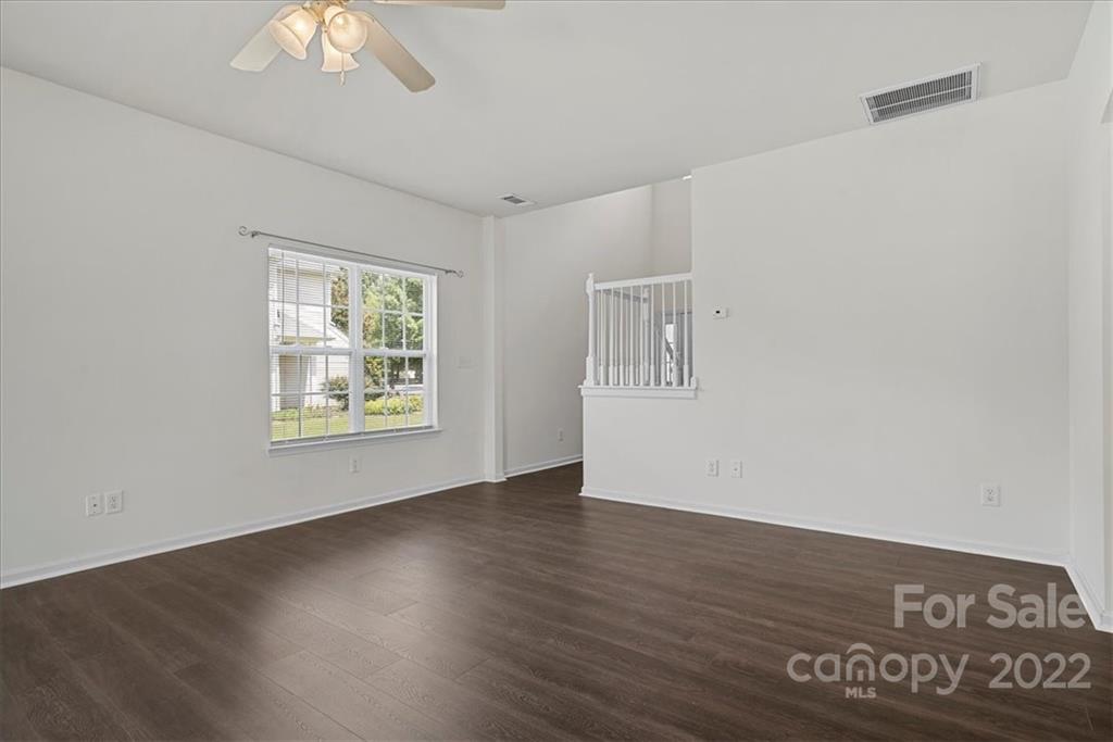 1224 Afternoon Sun Road Matthews, NC 28104 - Photo 9 of 22 a view of an empty room with a window and wooden floor