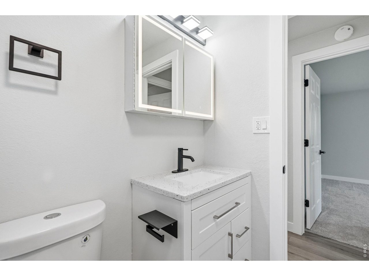 1035 6th Street Berthoud, CO 80513 - Photo 22 of 37 a bathroom with a sink vanity and a mirror