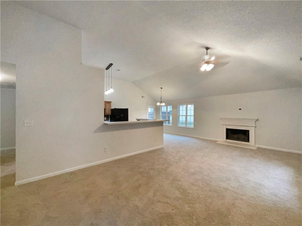 5945 Raventree Court Atlanta, GA 30349 - Photo 15 of 27 an empty room with fireplace and windows