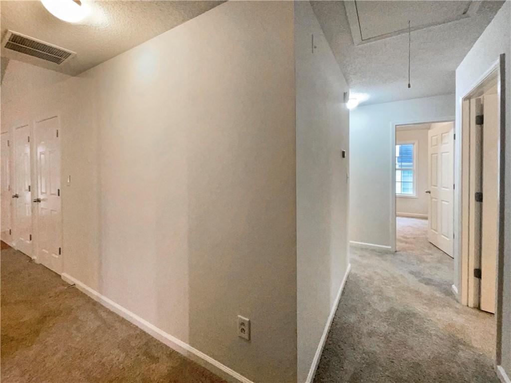 5945 Raventree Court Atlanta, GA 30349 - Photo 23 of 27 a view of a hallway with wooden floor