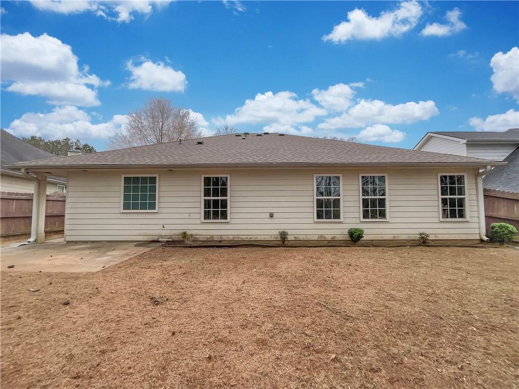 5945 Raventree Court Atlanta, GA 30349 - Photo 26 of 27 a view of a house with a backyard