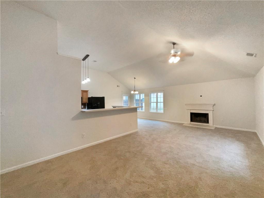 5945 Raventree Court Atlanta, GA 30349 - Photo 3 of 27 a view of a livingroom with a fireplace and chandelier fan