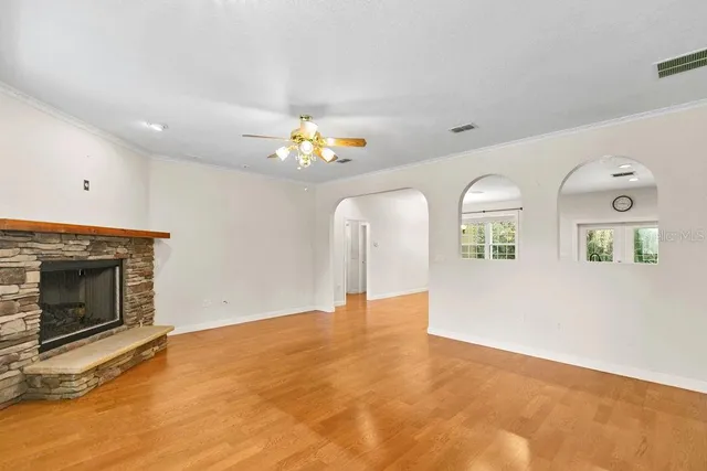 a view of an empty room with a fireplace