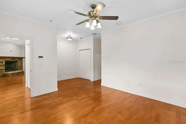 a view of an empty room with wooden floor