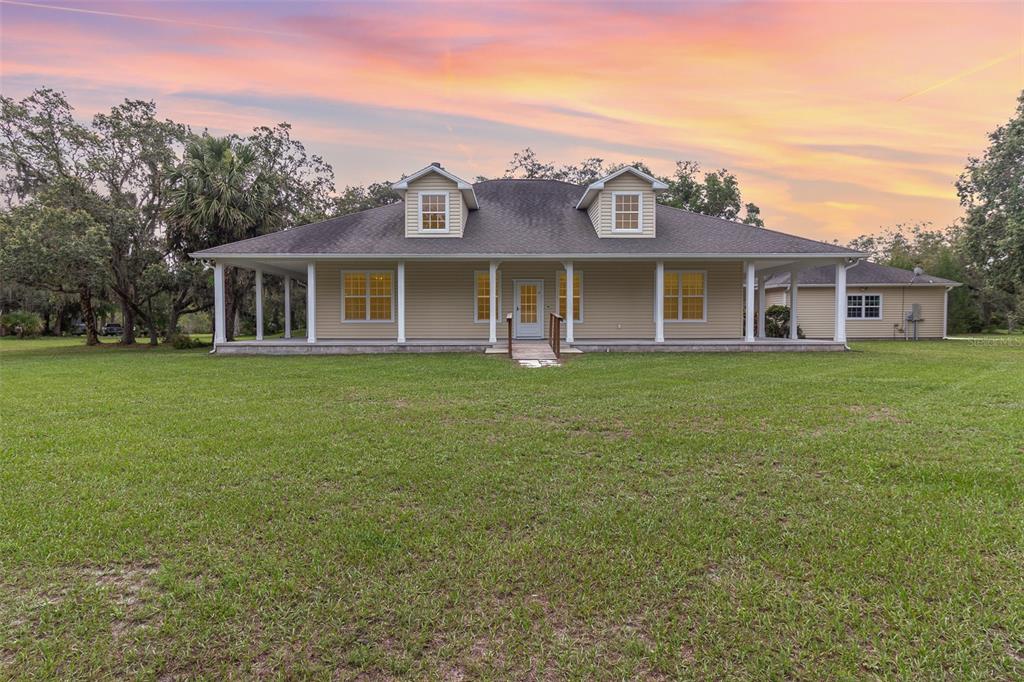 2691 Phillips Road Christmas, FL 32709 - Photo 2 of 38 a view of a house with a big yard and large trees
