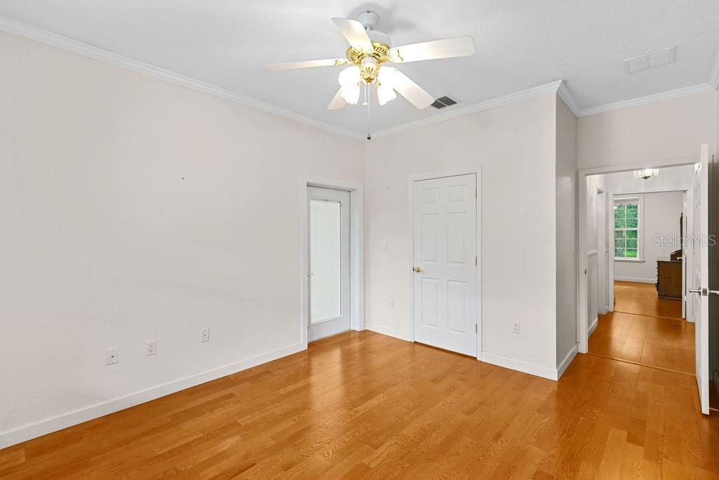 2691 Phillips Road Christmas, FL 32709 - Photo 26 of 38 a view of a big room with wooden floor and a chandelier fan