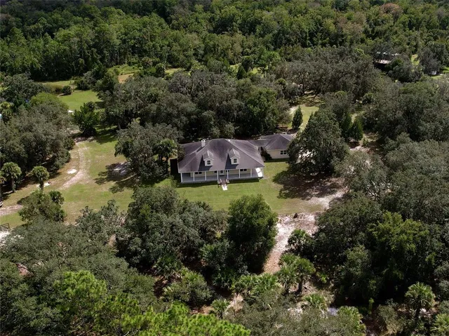 an aerial view of a house with a yard