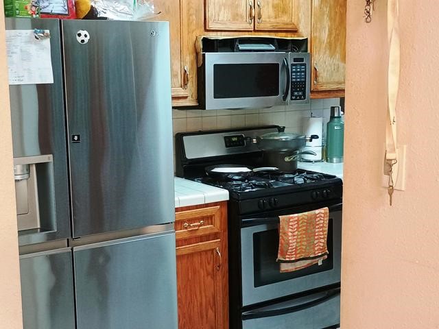 3822 Mattingham Drive Houston, TX 77066 - Photo 9 of 18 a kitchen with granite countertop a stove and a microwave