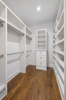 a view of walk in closet with empty racks