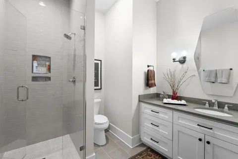 a bedroom with a bed and glass door