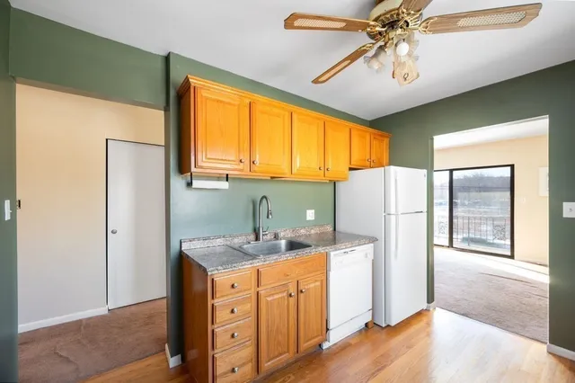 a kitchen with stainless steel appliances a refrigerator and a chandelier