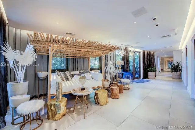 a living room with furniture and a floor to ceiling window