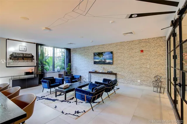a living room with furniture a large window and a flat screen tv
