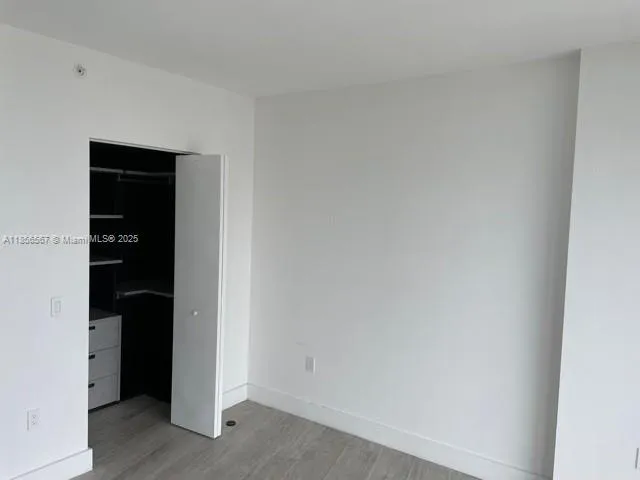 a kitchen with granite countertop white cabinets and stainless steel appliances