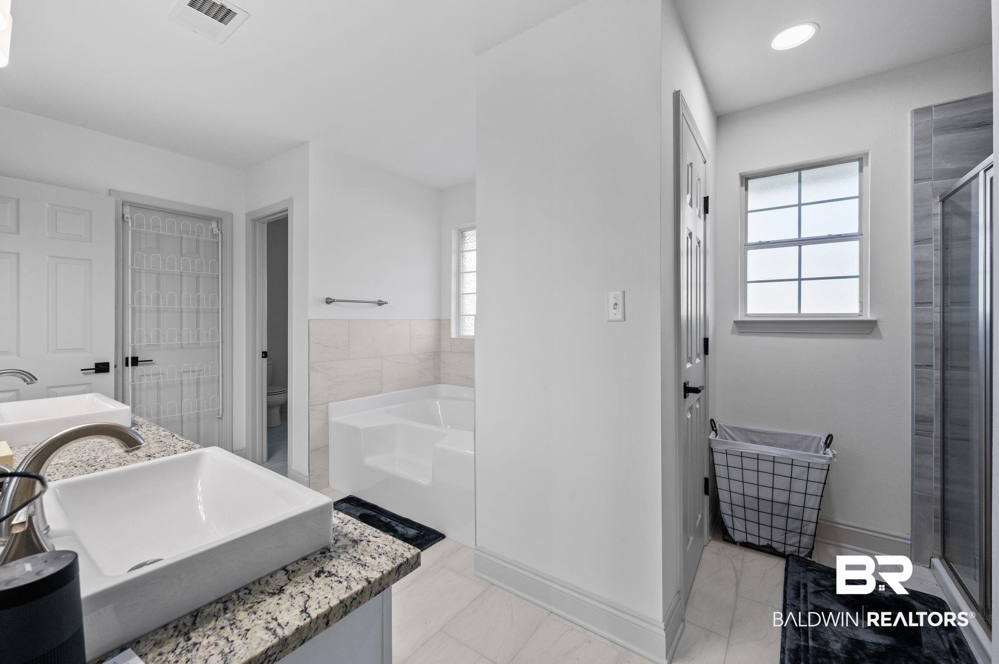 136 Destrehan Road Fairhope, AL 36532 - Photo 27 of 44 Bathroom with independent shower and bath, tile patterned floors, and vanity