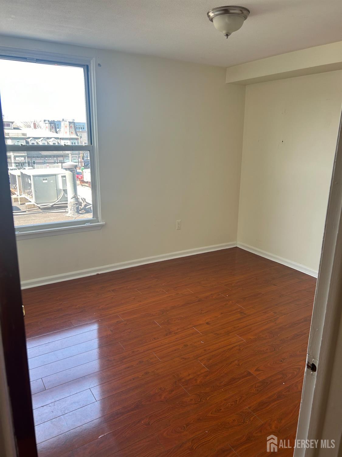 435 Main Street, Unit 2D Metuchen, NJ 08840 - Photo 8 of 8 an empty room with a window