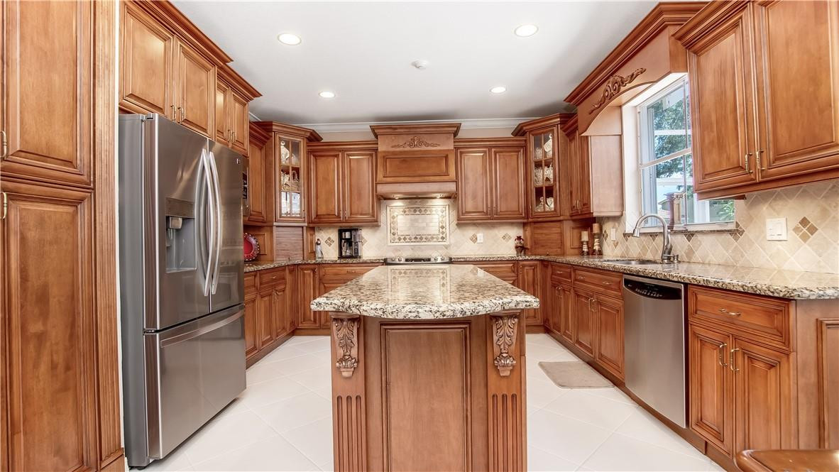 934 Crestview Circle Fort Lauderdale, FL 33327 - Photo 17 of 51 a kitchen with stainless steel appliances granite countertop a refrigerator a sink and a stove
