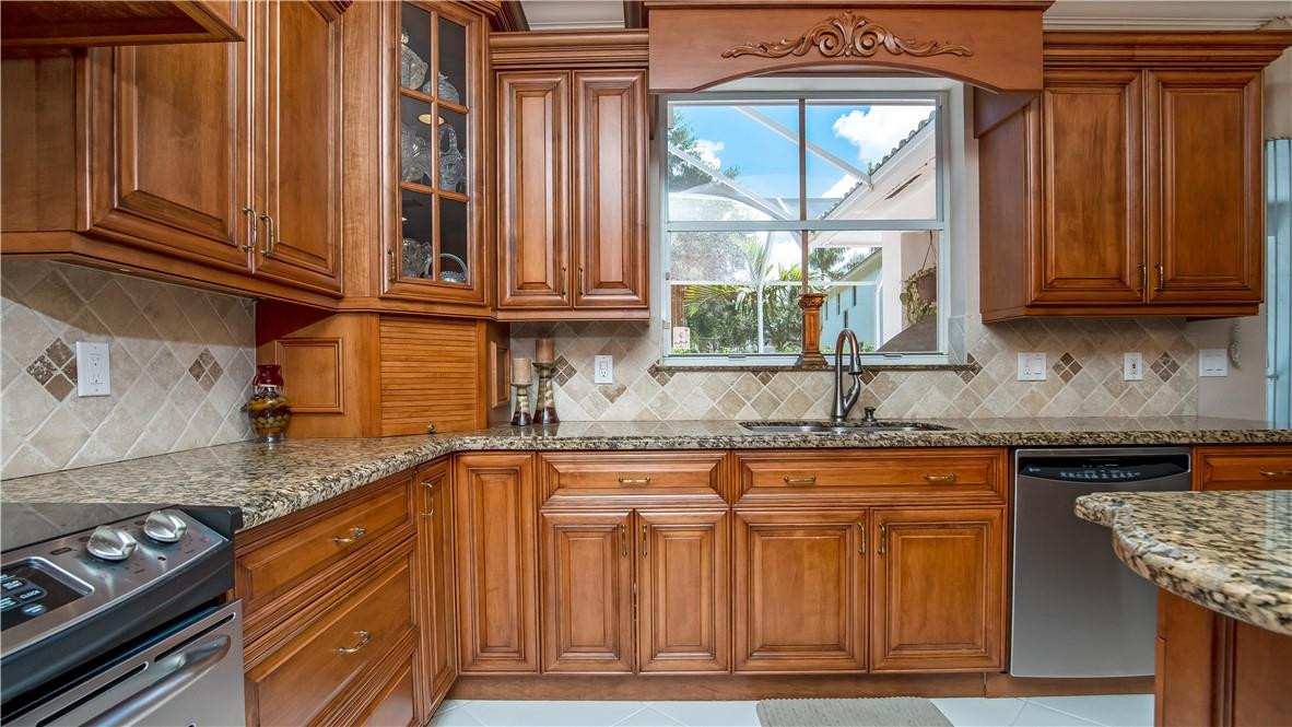934 Crestview Circle Fort Lauderdale, FL 33327 - Photo 19 of 51 a kitchen with granite countertop a sink a stove and cabinets