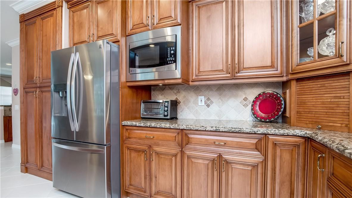934 Crestview Circle Fort Lauderdale, FL 33327 - Photo 20 of 51 a kitchen with stainless steel appliances granite countertop a refrigerator and microwave