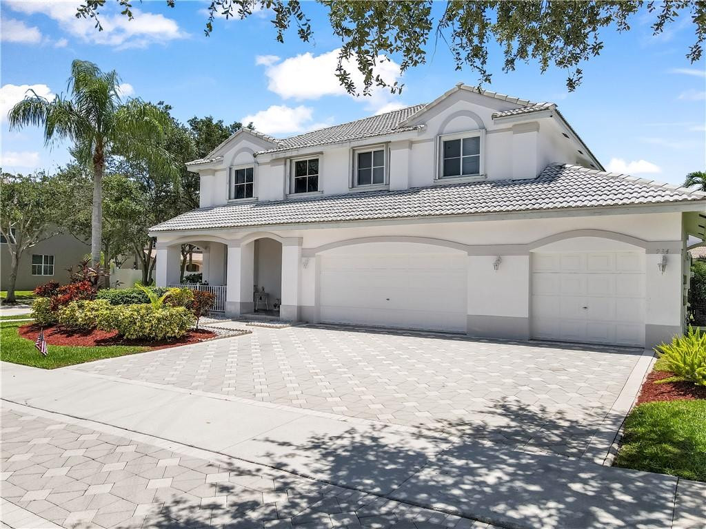 934 Crestview Circle Fort Lauderdale, FL 33327 - Photo 2 of 51 a front view of a house with a garden