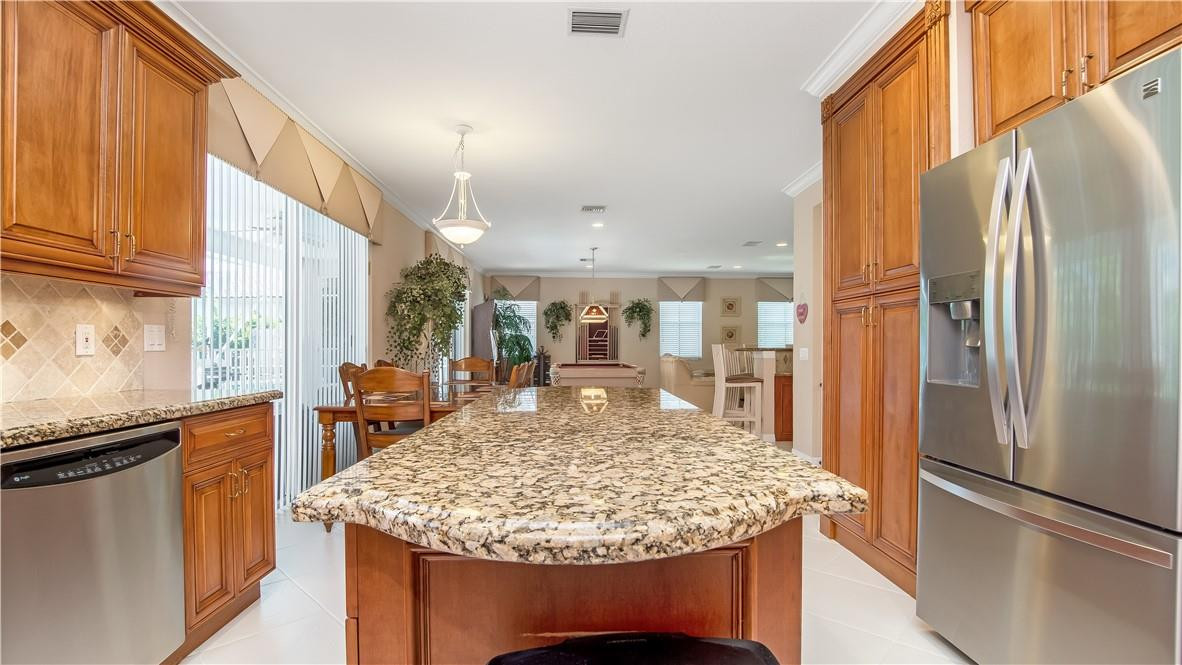 934 Crestview Circle Fort Lauderdale, FL 33327 - Photo 21 of 51 a kitchen with stainless steel appliances granite countertop kitchen island a refrigerator a stove and a sink