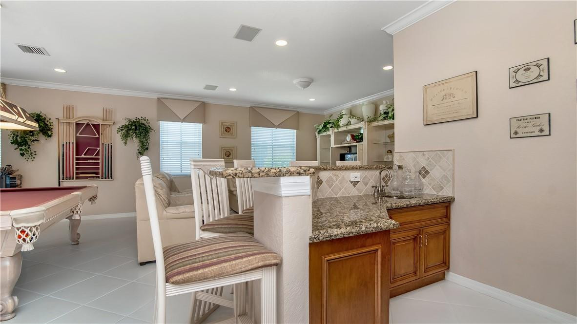 934 Crestview Circle Fort Lauderdale, FL 33327 - Photo 27 of 51 a kitchen with stainless steel appliances kitchen island granite countertop a refrigerator and stove