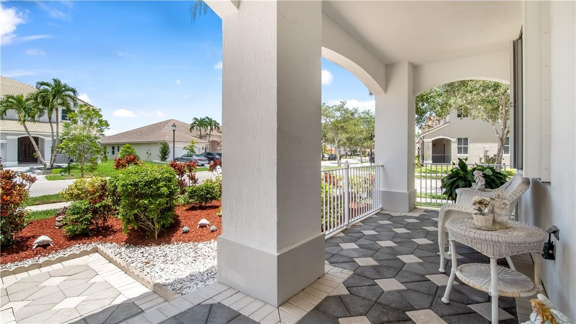 934 Crestview Circle Fort Lauderdale, FL 33327 - Photo 47 of 51 a view of a porch with chairs and potted plants