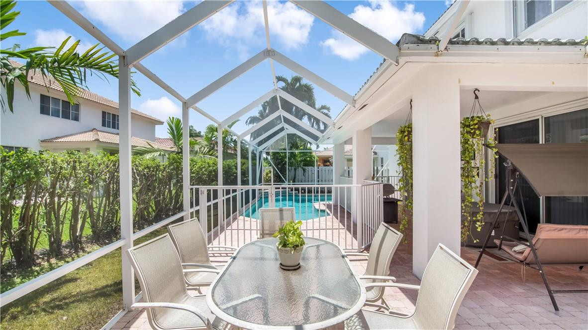 934 Crestview Circle Fort Lauderdale, FL 33327 - Photo 50 of 51 a view of a patio with couches table and chairs and potted plants