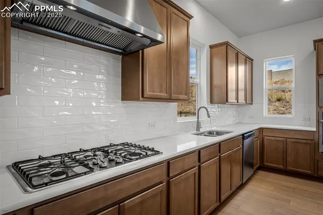 a kitchen with sink a stove and cabinets