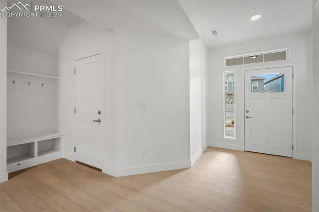 an empty room with wooden floor and closet