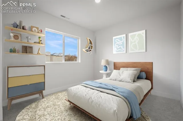 a bedroom with a bed and painting on the wall