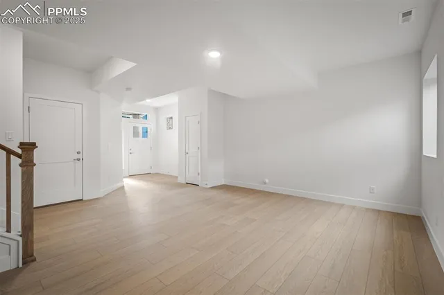 an empty room with wooden floor