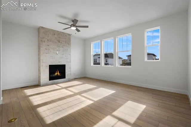 a view of an empty room with a fireplace and a window