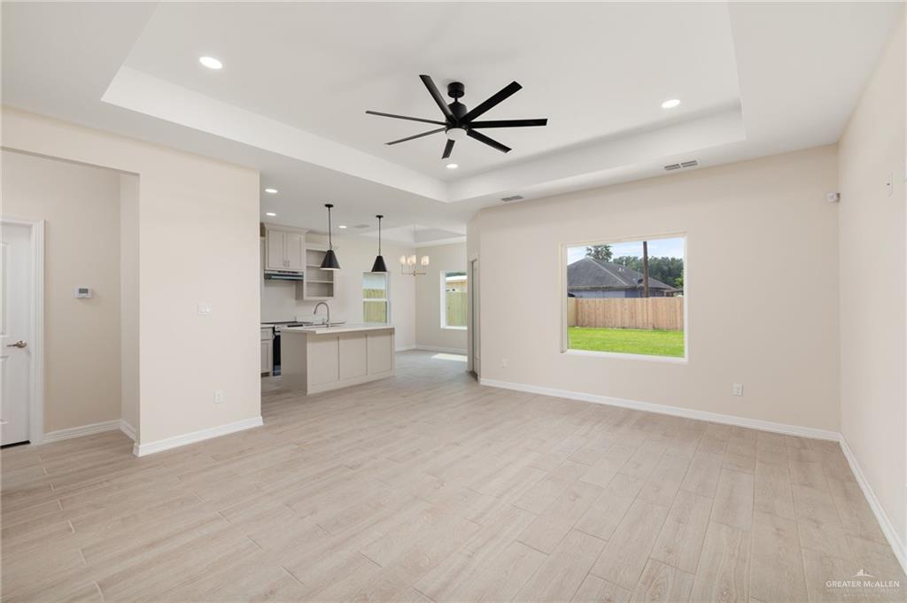 1717 Alisson Street Alton, TX 78573 - Photo 2 of 15 a view of an empty room with a window and kitchen view