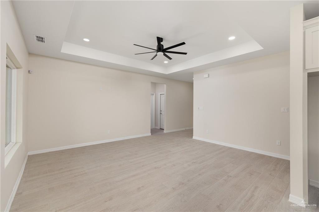 1717 Alisson Street Alton, TX 78573 - Photo 3 of 15 an empty room with a ceiling fan and carpet