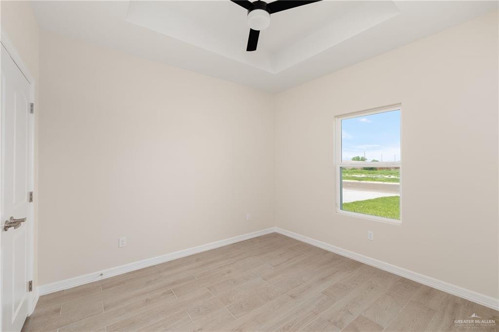 1717 Alisson Street Alton, TX 78573 - Photo 9 of 15 an empty room with a window and a ceiling fan