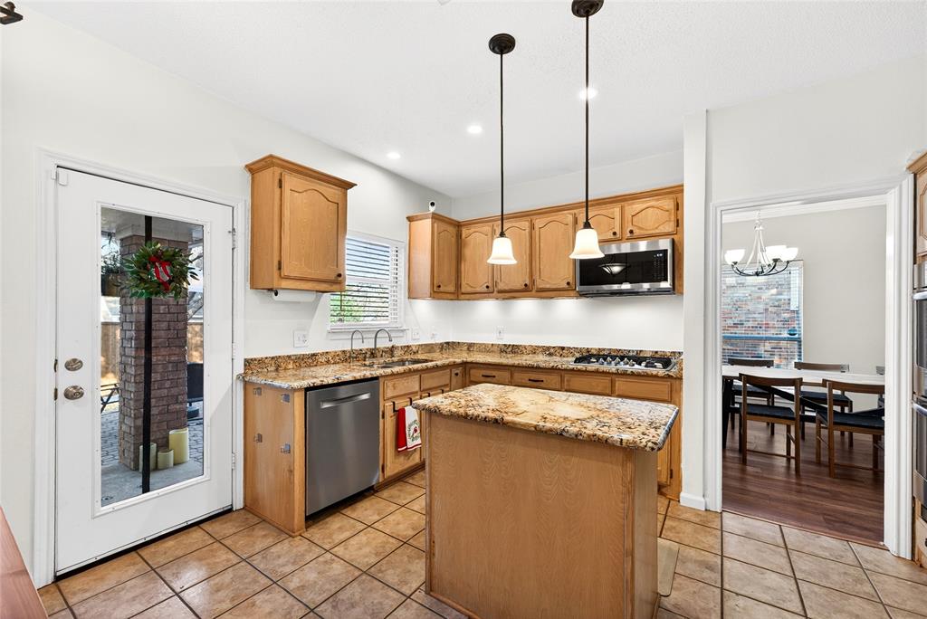 1804 Hunters Ridge Drive Grapevine, TX 76051 - Photo 2 of 36 Large kitchen with island and access to back yard