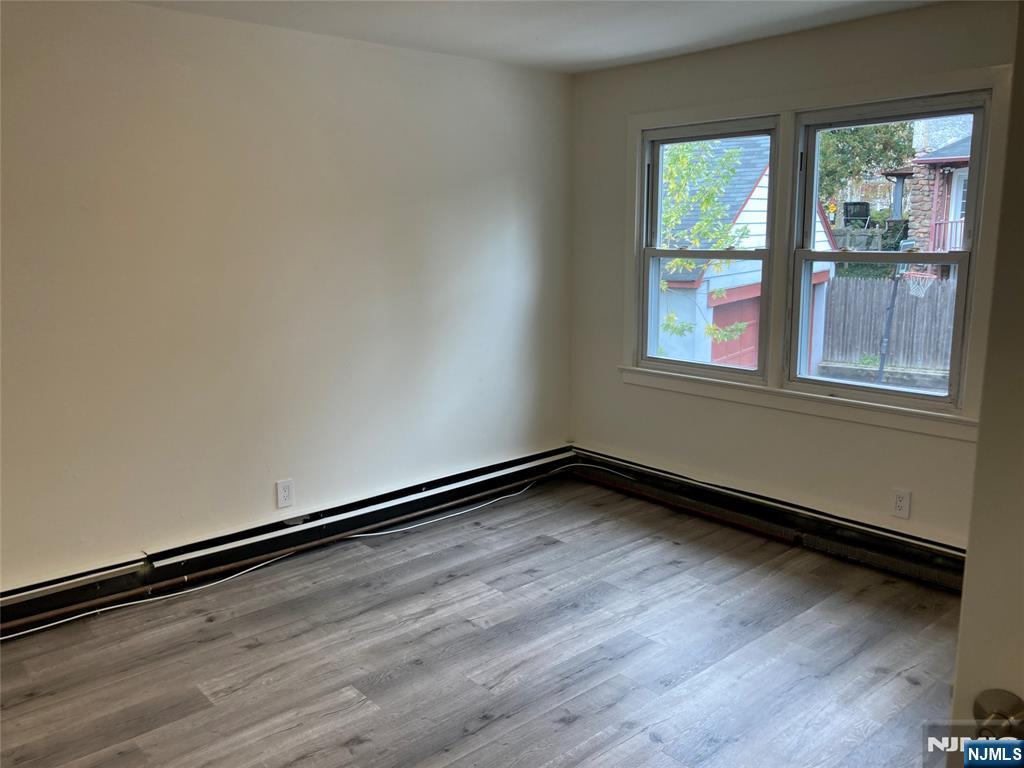 118 Doremus Avenue, Unit C Ridgewood, NJ 07450 - Photo 11 of 16 a view of a room with wooden floor and window