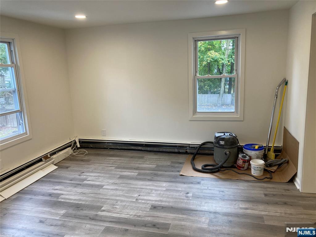 118 Doremus Avenue, Unit C Ridgewood, NJ 07450 - Photo 12 of 16 a view of a room with wooden floor and window