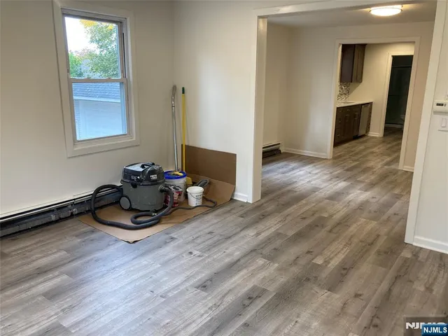 a dining room with wooden floor and furniture