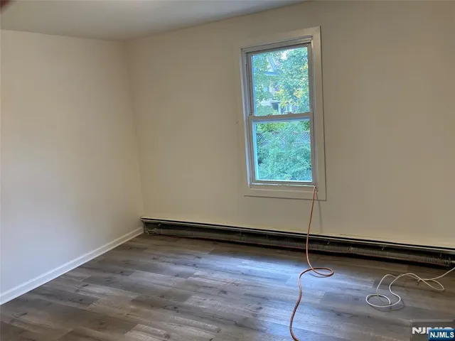 a view of a room with wooden floor and window