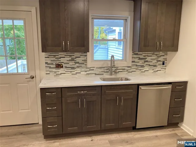 a kitchen with granite countertop cabinets sink and window