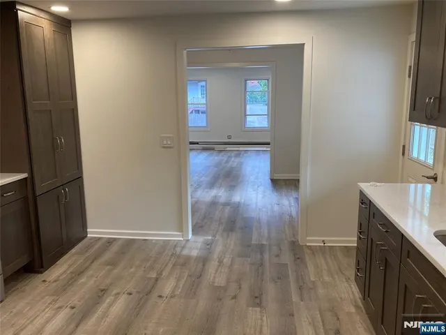 a view of hallway with wooden floor